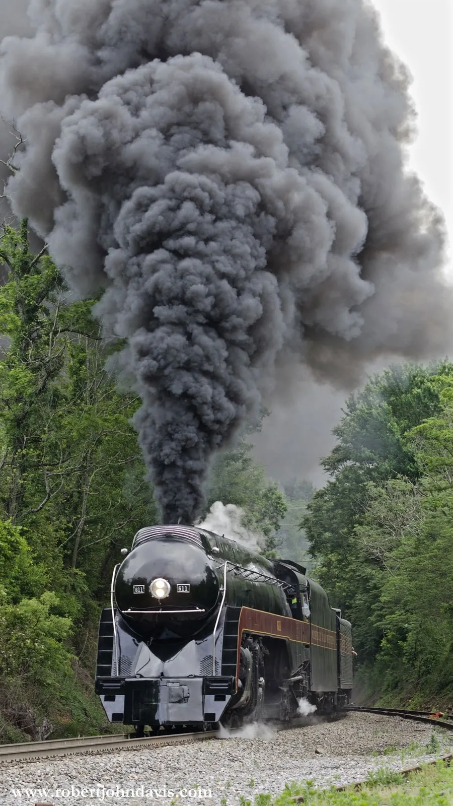 After almost being defeated by a light rain and slick rails on the eastern slope of the Blue Ridge, #611 has crested Linden Hill and is rolling downgrade towards Front Royal, VA on Sunday morning. Photo by Robert John Davis.
